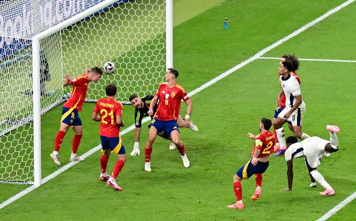 Soccer Football - Euro 2024 - Final - Spain v England - Berlin Olympiastadion, Berlin, Germany - July 14, 2024 Spains Dani Olmo in action as he heads the ball off the line REUTERS/Angelika Warmuth     TPX IMAGES OF THE DAY