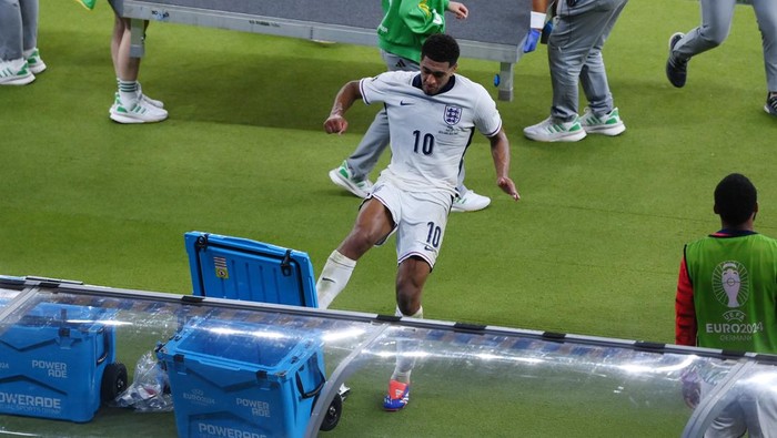 BERLIN, GERMANY - JULY 14: Jude Bellingham of England reacts after defeat to Spain as he kicks over a Powerade Cooler Box as he leaves the field after the UEFA EURO 2024 final match between Spain and England at Olympiastadion on July 14, 2024 in Berlin, Germany. (Photo by Justin Setterfield/Getty Images)
