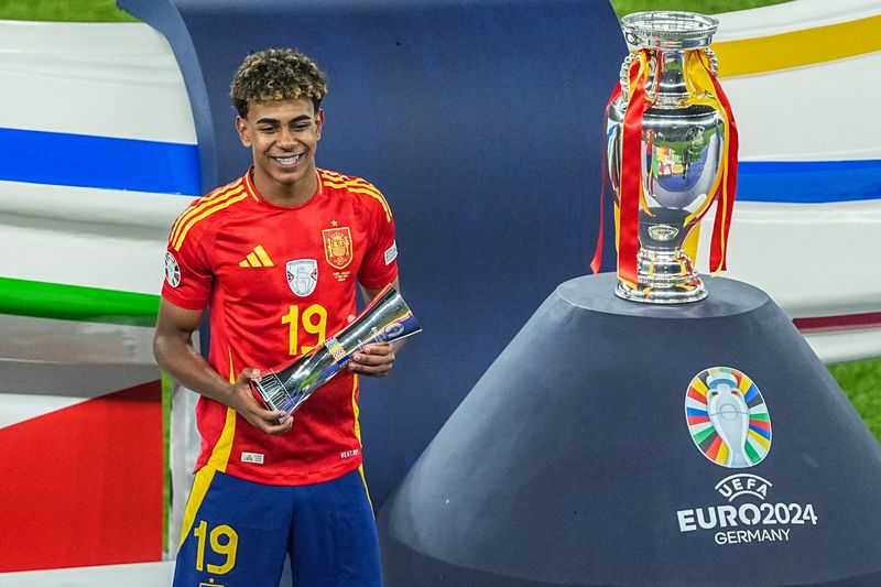 14 July 2024, Berlin: Soccer: European Championship, Spain - England, final round, final, Olympiastadion Berlin, Spain's Lamine Yamal with the trophy for the best young player of the tournament. Photo: Michael Kappeler/dpa (Photo by Michael Kappeler/picture alliance via Getty Images)