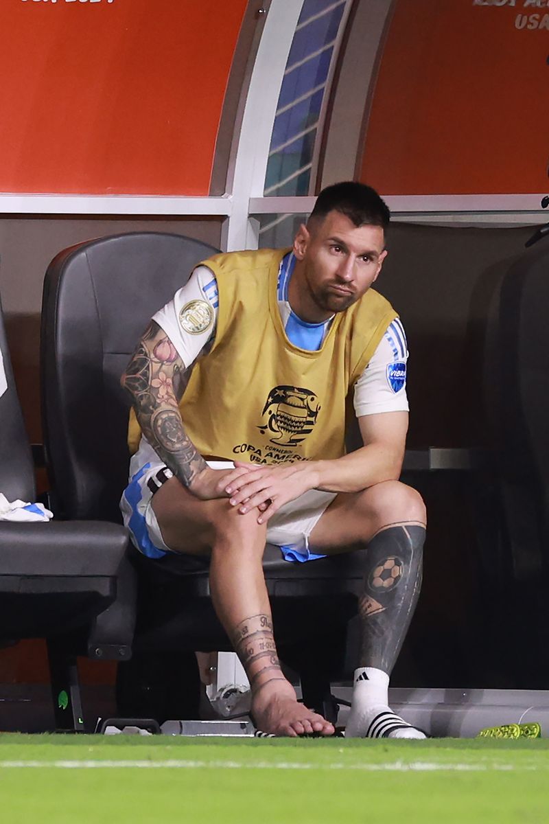  Lionel Messi of Argentina watches the actions from the bench after leaving the pitch with an injury during the CONMEBOL Copa America 2024 Final match between Argentina and Colombia at Hard Rock Stadium on July 14, 2024 in Miami Gardens, Florida. (Photo by Carmen Mandato/Getty Images)