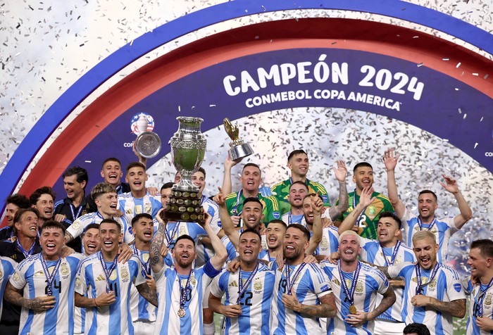 SOCCER-COPA-ARG-COL/REPORT Soccer Football - Copa America 2024 - Final - Argentina v Colombia - Hard Rock Stadium, Miami, Florida, United States - July 15, 2024 Argentina's Lionel Messi lifts the trophy as he celebrates with teammates after winning Copa America 2024 REUTERS/Agustin Marcarian
