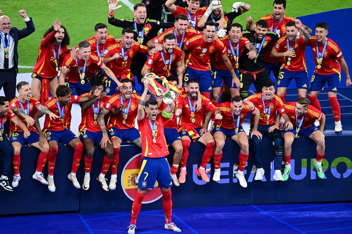 Soccer Football - Euro 2024 - Final - Spain v England - Berlin Olympiastadion, Berlin, Germany - July 14, 2024 Spains Alvaro Morata celebrates with the trophy and teammates after winning Euro 2024 REUTERS/Angelika Warmuth