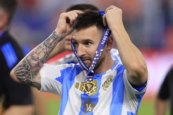 MIAMI GARDENS, FLORIDA - JULY 14: Lionel Messi of Argentina puts on his medal after a victory in the CONMEBOL Copa America 2024 Final match between Argentina and Colombia at Hard Rock Stadium on July 15, 2024 in Miami Gardens, Florida. (Photo by Buda Mendes/Getty Images)