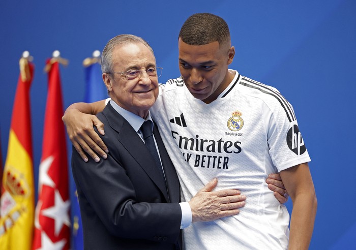 Soccer Football - Real Madrid unveil Kylian Mbappe - Santiago Bernabeu, Madrid, Spain - July 16, 2024 New Real Madrid signing Kylian Mbappe hugs club president Florentino Perez on stage during the presentation REUTERS/Juan Medina