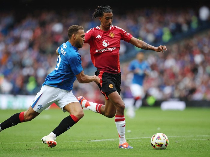 Soccer Football - Pre Season Friendly - Rangers v Manchester United - Murrayfield Stadium, Edinburgh, Scotland, Britain - July 20, 2024 Rangers Cyriel Dessers in action with Manchester Uniteds Leny Yoro Action Images via Reuters/Ed Sykes