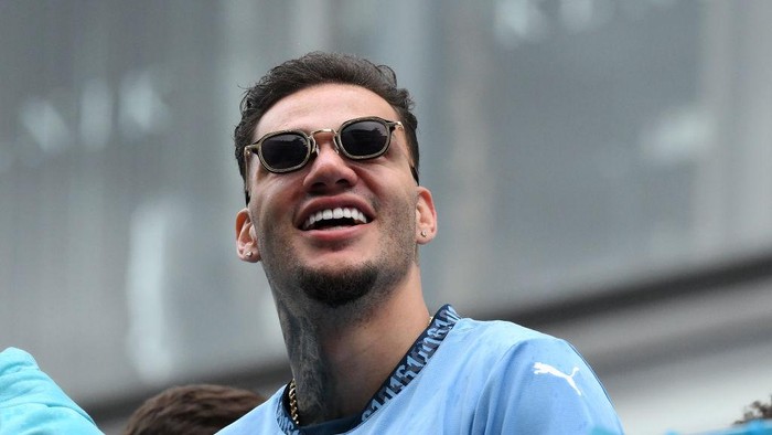 MANCHESTER, ENGLAND - MAY 26: Ederson of Manchester City looks on as he celebrates with teammates on the Open Top Bus during the Manchester City trophy parade on May 26, 2024 in Manchester, England. (Photo by Ben Roberts Photo/Getty Images)