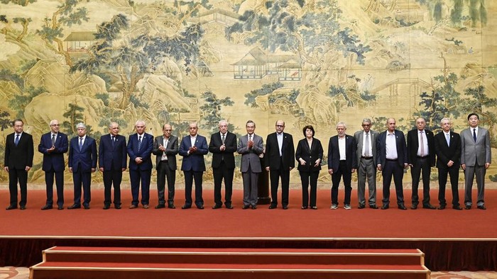 China's Foreign Minister Wang Yi, center, hosts an event for Mahmoud al-Aloul, left, vice chairman of Fatah, and Mussa Abu Marzuk, a senior member of Hamas, to meet at the Diaoyutai State Guesthouse in Beijing, Tuesday, July 23, 2024. (Pedro Pardo/Pool Photo via AP)