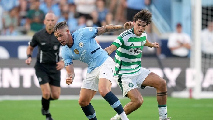 CHAPEL HILL, NORTH CAROLINA - JULY 23:  Kalvin Phillips #4 of Manchester City challenges Matt ORiley #33 of Celtic during the pre-season friendly match at Kenan Stadium on July 23, 2024 in Chapel Hill, North Carolina.  (Photo by Grant Halverson/Getty Images)