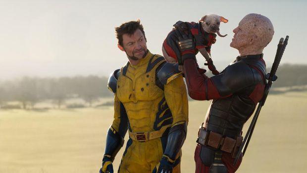 (L-R): Ryan Reynolds as Deadpool/Wade Wilson, Dogpool, and Hugh Jackman as Wolverine/Logan in 20th Century Studios/Marvel Studios' DEADPOOL & WOLVERINE. Photo by Jay Maidment. © 2024 20th Century Studios / © and ™ 2024 MARVEL.