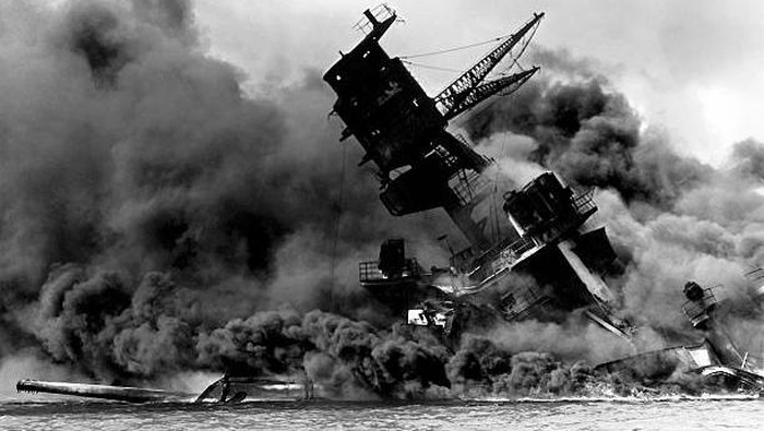 Vintage World War II photo of the USS Arizona burning after the Japanese attack on Pearl Harbor, December 7, 1941.