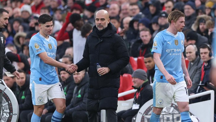 LIVERPOOL, ENGLAND - MARCH 10: Pep Guardiola the manager of Manchester City looks on after substituting Julian Alvarez and Kevin De Bruyne during the Premier League match between Liverpool FC and Manchester City at Anfield on March 10, 2024 in Liverpool, England. (Photo by Alex Livesey - Danehouse/Getty Images)