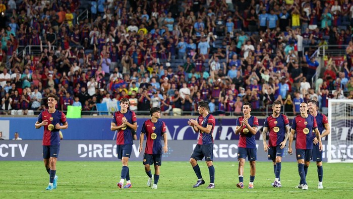 Jul 30, 2024; Orlando, FL, USA; Barcelona celebrate after beating Manchester City on penalty kicks in a tie breaker during a Champions Tour friendly match at Camping World Stadium. Mandatory Credit: Nathan Ray Seebeck-USA TODAY Sports