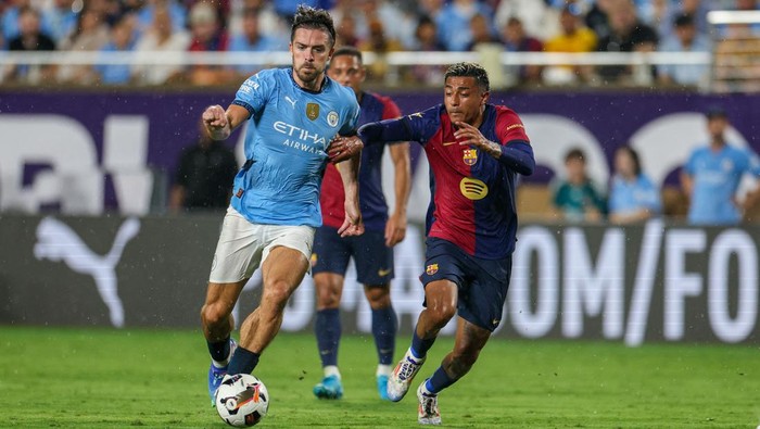 Jul 30, 2024; Orlando, FL, USA; Manchester City midfielder Jack Grealish (10) controls the ball against Barcelona in the first half  during a Champions Tour friendly match at Camping World Stadium. Mandatory Credit: Nathan Ray Seebeck-USA TODAY Sports