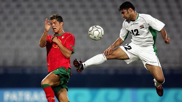 PATRAS, GREECE - AUGUST 12:  Cristiano Ronaldo of Portugal and Haidar Abdul Razzaq of Iraq compete in the men's football preliminary match between Iraq and Portugal during the Athens 2004 Summer Olympic Games at Pampeloponnisiako Stadium on August 12, 2004 in Patras, Greece. (Photo by Clive Brunskill/Getty Images)