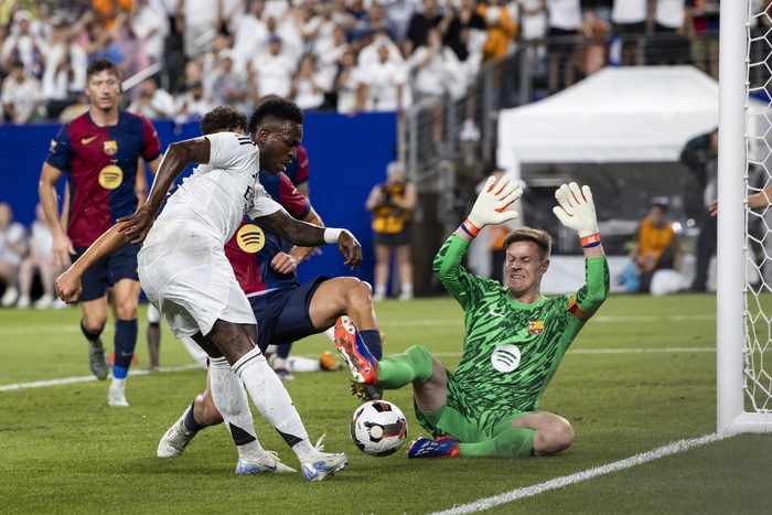 EAST RUTHERFORD, NEW JERSEY - AUGUST 3: Marc-Andre ter Stegen #1 of FC Barcelona blocks the shot on goal by Vinícius Junior #7 of Real Madrid in the second half of the pre-season friendly match at MetLife Stadium on August 3, 2024 in East Rutherford, New Jersey. (Photo by Ira L. Black/Getty Images)