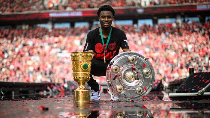 LEVERKUSEN, GERMANY - MAY 26: Nathan Tella of Leverkusen posing with the Meisterschale and the DFB Pokal during the Bayer 04 Leverkusen champions party on May 26, 2024 in Leverkusen, Germany.(Photo by Jörg Schüler/Bayer 04 Leverkusen via Getty Images)