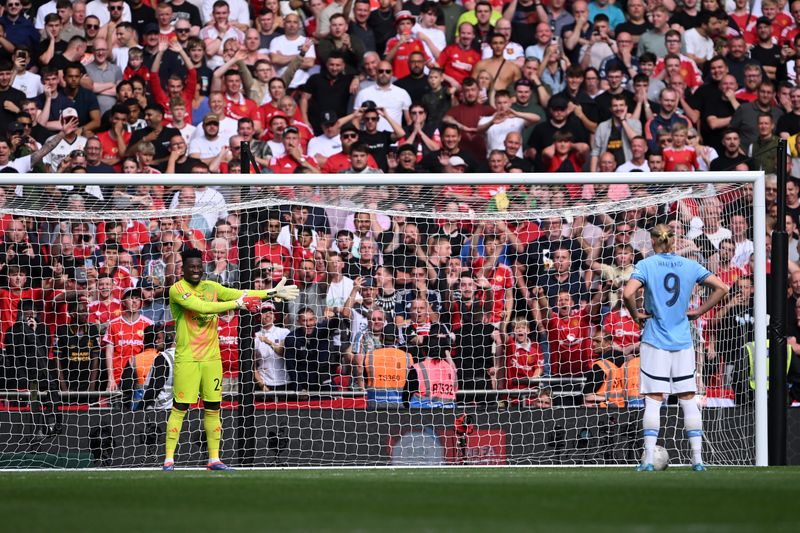  Andre Onana of Manchester United gestures as Erling Haaland of Manchester City prepares to take his team's third penalty in the penalty shoot out  during the 2024 FA Community Shield match between Manchester United and Manchester City at Wembley Stadium on August 10, 2024 in London, England. (Photo by Stu Forster/Getty Images)