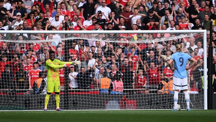 LONDON, ENGLAND - AUGUST 10: Andre Onana of Manchester United gestures as Erling Haaland of Manchester City prepares to take his teams third penalty in the penalty shoot out  during the 2024 FA Community Shield match between Manchester United and Manchester City at Wembley Stadium on August 10, 2024 in London, England. (Photo by Stu Forster/Getty Images)