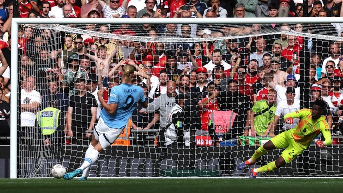 LONDON, ENGLAND - AUGUST 10: Andre Onana of Manchester United dives for the ball as Erling Haaland of Manchester City scores his teams third penalty in the penalty shoot out  during the 2024 FA Community Shield match between Manchester United and Manchester City at Wembley Stadium on August 10, 2024 in London, England. (Photo by Eddie Keogh - The FA/The FA via Getty Images)