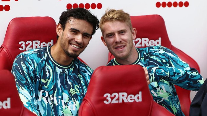 MIDDLESBROUGH, ENGLAND - AUGUST 10: (L-R) Nathan T-Joe-On and Oliver Cooper of Swansea City sit on the bench prior to the Sky Bet Championship match between Middlesbrough and Swansea City at the Riverside Stadium on August 10, 2024 in Middlesbrough, England. (Photo by Athena Pictures/Getty Images)