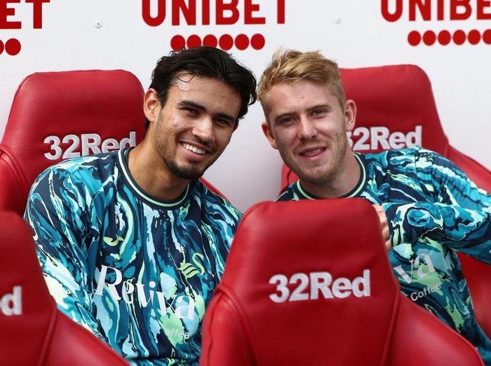 MIDDLESBROUGH, ENGLAND - AUGUST 10: (L-R) Nathan T-Joe-On and Oliver Cooper of Swansea City sit on the bench prior to the Sky Bet Championship match between Middlesbrough and Swansea City at the Riverside Stadium on August 10, 2024 in Middlesbrough, England. (Photo by Athena Pictures/Getty Images)
