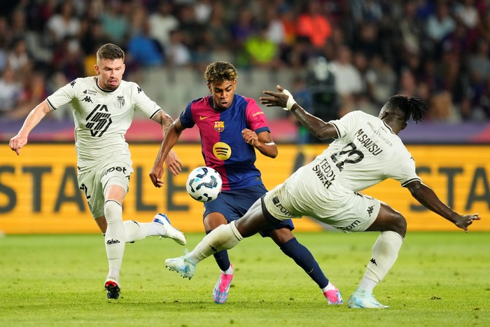 Lamine Yamal right wingerof Barcelona and Spain and Mohammed Salisu centre-back of Monaco and Ghana compete for the ball during the Joan Gmaper Trophy match between FC Barcelona and AS Monaco at Estadi Olimpic Lluis Companys on August 12, 2024 in Barcelona, Spain. (Photo by Jose Breton/Pics Action/NurPhoto via Getty Images)