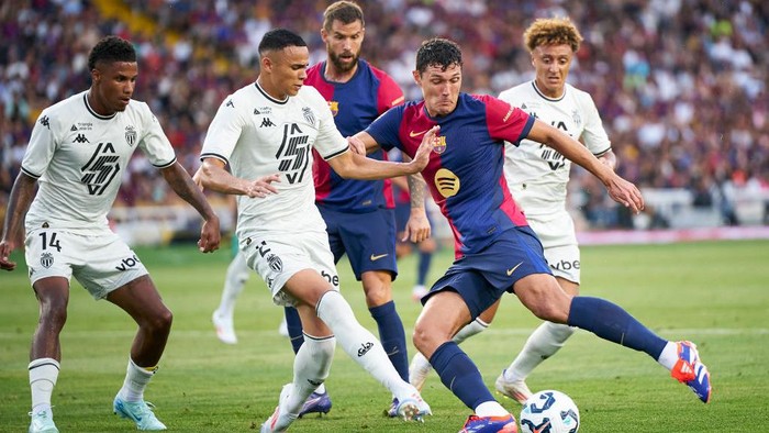BARCELONA, SPAIN - AUGUST 12: Andreas Christensen of FC Barcelona competes for the ball with Vanderson de Oliveira Campos of AS Monaco during the Trofeu Joan Gamper match between FC Barcelona and AS Monaco at Estadi Olimpic Lluis Companys on August 12, 2024 in Barcelona, Spain. (Photo by Manuel Queimadelos/Quality Sport Images/Getty Images)