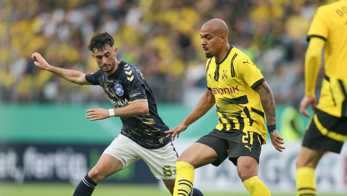 LUEBECK, GERMANY - AUGUST 17:  Fabio Maiolo of Lübeck fights for the ball with Valdemar Sadrifar of Lübeck during the DFB-Pokal match between 1. FC Phönix Lübeck and Borussia Dortmund at  on August 17, 2024 in Luebeck, Germany. (Photo by Selim Sudheimer/Getty Images)