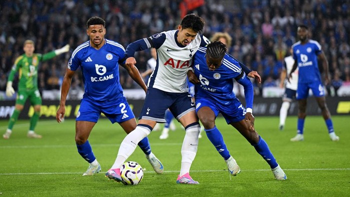 LEICESTER, ENGLAND - AUGUST 19: Son Heung-Min of Tottenham Hotspur (centre) battles for possession with Abdul Fatawu of Leicester City during the Premier League match between Leicester City FC and Tottenham Hotspur FC at The King Power Stadium on August 19, 2024 in Leicester, England. (Photo by Michael Regan/Getty Images)