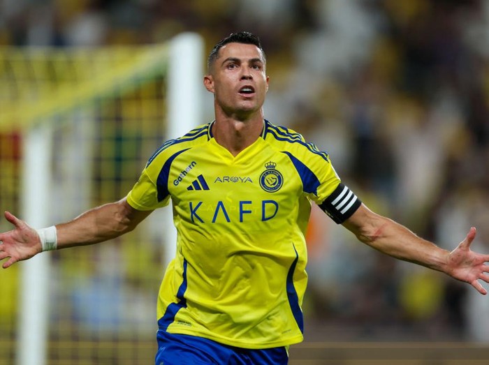 RIYADH, SAUDI ARABIA - AUGUST 22: Cristiano Ronaldo of Al Nassr celebrating after scores the 1st goal during the Saudi Pro League match between Al Nassr and Al Raed at Al Awwal Park Stadium on August 22, 2024 in Riyadh, Saudi Arabia. (Photo by Yasser Bakhsh/Getty Images)