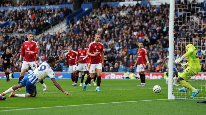 BRIGHTON, ENGLAND - AUGUST 24: Joao Pedro of Brighton & Hove Albion scores his teams second goal as Andre Onana of Manchester United fails to make the save during the Premier League match between Brighton & Hove Albion FC and Manchester United FC at Amex Stadium on August 24, 2024 in Brighton, England. (Photo by Eddie Keogh/Getty Images)