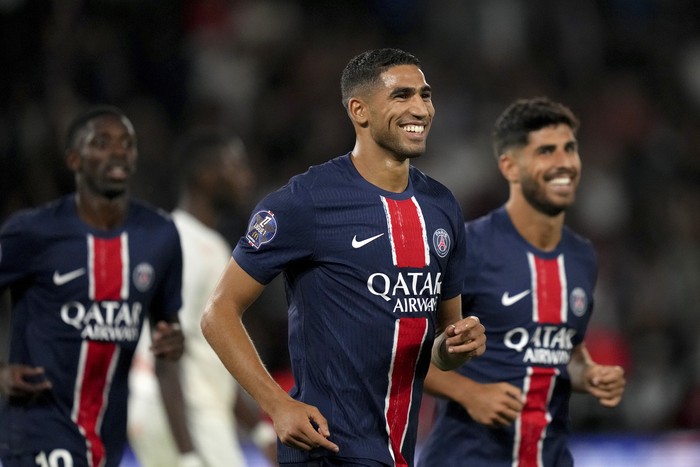 PSGs Achraf Hakimi smiles after scoring his sides fourth goal during the French League 1 soccer match between Paris Saint-Germain and Montpellier at the Parc des Princes in Paris, Friday, Aug. 23, 2024. (AP Photo/Thibault Camus)