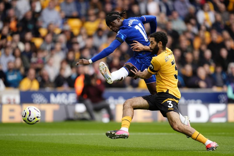 Chelsea's Noni Madueke, left, and Wolverhampton Wanderers' Rayan Ait-Nouri battle for the ball during the English Premier League soccer match between Wolverhampton Wanderers and Chelsea at Molineux Stadium, Wolverhampton, England. Sunday Aug. 25, 2024. (Nick Potts/PA via AP)