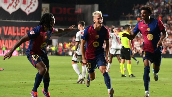 MADRID, SPAIN - AUGUST 27: Dani Olmo of FC Barcelona (C) celebrates scoring his sides second goal with teammates Jules Kounde (L) and Alejandro Balde (R) during the La Liga match between Rayo Vallecano and FC Barcelona at Estadio de Vallecas on August 27, 2024 in Madrid, Spain. (Photo by Denis Doyle/Getty Images)