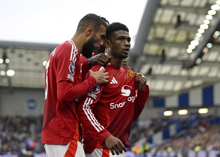 Soccer Football - Premier League - Brighton & Hove Albion v Manchester United - The American Express Community Stadium, Brighton, Britain - August 24, 2024 Manchester Uniteds Amad Diallo celebrates scoring their first goal with Noussair Mazraoui REUTERS/Tony O Brien EDITORIAL USE ONLY. NO USE WITH UNAUTHORIZED AUDIO, VIDEO, DATA, FIXTURE LISTS, CLUB/LEAGUE LOGOS OR LIVE SERVICES. ONLINE IN-MATCH USE LIMITED TO 120 IMAGES, NO VIDEO EMULATION. NO USE IN BETTING, GAMES OR SINGLE CLUB/LEAGUE/PLAYER PUBLICATIONS. PLEASE CONTACT YOUR ACCOUNT REPRESENTATIVE FOR FURTHER DETAILS..
