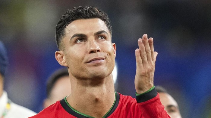 HAMBURG, GERMANY - JULY 5: Portugals forward Cristiano Ronaldo dejected following Theo Hernandezs penalty gives victory to France in the UEFA Euro 2024 quarter-final football match between Portugal and France at the Volksparkstadion in Hamburg on July 5, 2024. (Photo by Emin Sansar/Anadolu via Getty Images)