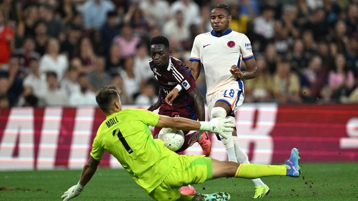 GENEVA, SWITZERLAND - AUGUST 29: Christopher Nkunku of Chelsea shoots under pressure from Bradley Mazikou of Servette, which is saved by Joel Mall of Servette  during the UEFA Europa Conference League Play-Offs Second Leg match between Servette FC and Chelsea FC at Stade de Geneve on August 29, 2024 in Geneva, Switzerland.  (Photo by Darren Walsh/Chelsea FC via Getty Images)