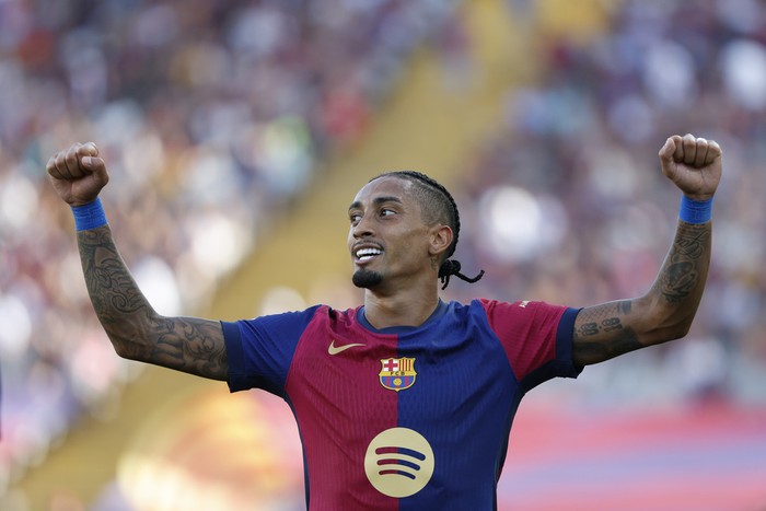 Barcelonas Raphinha celebrates scoring his sides 5th goal during the Spanish La Liga soccer match between FC Barcelona and Valladolid at the Olympic stadium in Barcelona, Spain, Saturday, Aug. 31, 2024. (AP Photo/Joan Monfort)