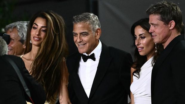 From left : Amal Clooney, actor George Clooney, Ines de Ramon and actor Brad Pitt arrive at the red carpet of the movie 