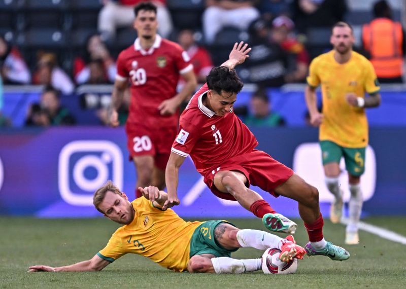 Nathaniel Atkinson (L) of Australia is battling for the ball with Rafael William Struck of Indonesia during the AFC Asian Cup 2023 round of 16 match between Australia and Indonesia at Jassim bin Hamad Stadium in Doha, Qatar, on January 28, 2023. (Photo by Noushad Thekkayil/NurPhoto via Getty Images)