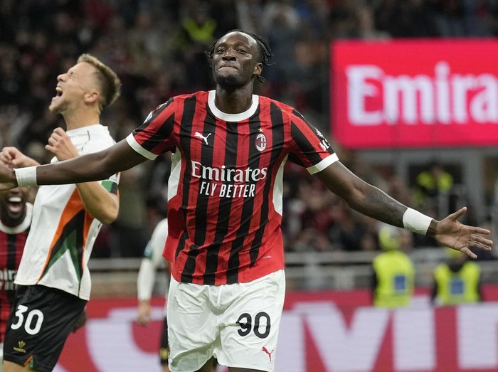 AC Milan's Tammy Abraham celebrates after he scored during the Serie A soccer match between AC Milan and Venezia at the San Siro stadium in Milan, Italy, Saturday, Sept. 14, 2024. (AP Photo/Antonio Calanni)