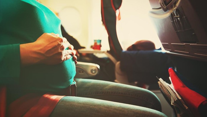 899082918 pregnant woman travel by plane, travel concept