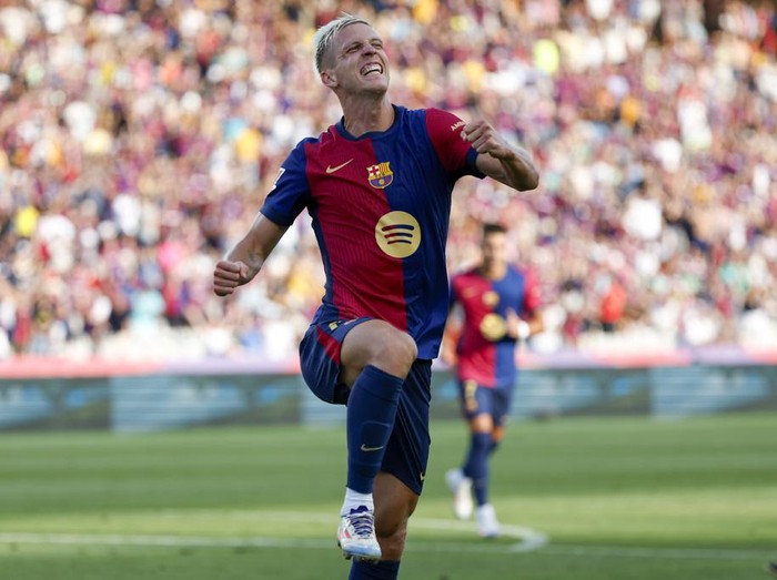 Barcelona's Dani Olmo celebrates scoring his side's 6th goal during the Spanish La Liga soccer match between FC Barcelona and Valladolid at the Olympic stadium in Barcelona, Spain, Saturday, Aug. 31, 2024. (AP Photo/Joan Monfort)