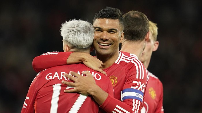 Manchester Uniteds Alejandro Garnacho is celebrated by Manchester Uniteds Casemiro after scoring his sides fourth goal during the English League Cup soccer match between Manchester United and Barnsley at Old Trafford, Manchester, England, Tuesday, Sept. 17, 2024. (AP Photo/Dave Thompson)