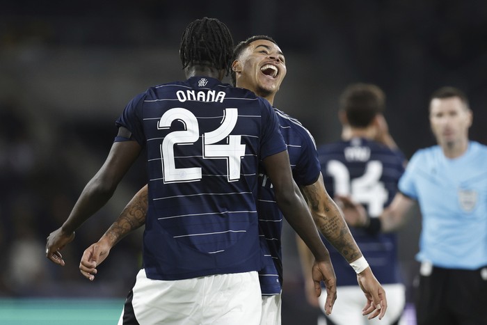 Aston Villas Amadou Onana, left, celebrates with his teammate Youri Tielemans, right, after scoring his sides third  goal during the Champions League opening phase soccer match between Young Boys Bern and Aston Villa in Bern, Switzerland, Tuesday, Sept. 17, 2024. (Peter Klaunzer/Keystone via AP)