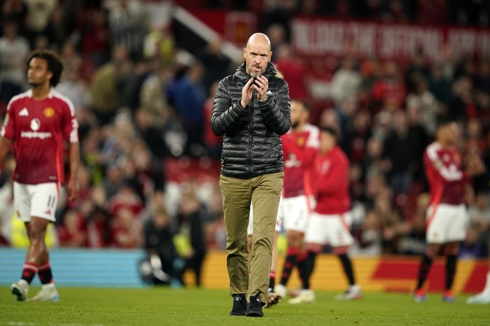 Manchester Uniteds head coach Erik ten Hag celebrates with supporters after winning the English League Cup soccer match between Manchester United and Barnsley at Old Trafford, Manchester, England, Tuesday, Sept. 17, 2024. (AP Photo/Dave Thompson)