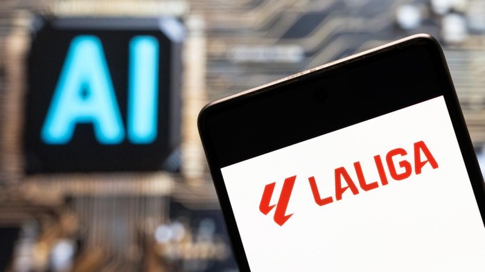 CHINA - 2023/11/03: In this photo illustration, the LaLiga logo seen displayed on a smartphone with an Artificial intelligence (AI) chip and symbol in the background. (Photo Illustration by Budrul Chukrut/SOPA Images/LightRocket via Getty Images)