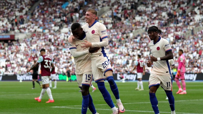 Chelseas Cole Palmer celebrates scoring their sides third goal of the game with Nicolas Jackson and Noni Madueke during the Premier League match at the London Stadium. Picture date: Saturday September 21, 2024. (Photo by Ben Whitley/PA Images via Getty Images)