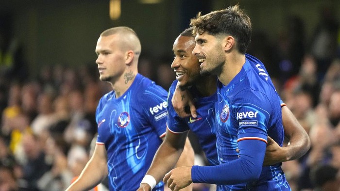 Chelseas Christopher Nkunku, centre, celebrates after scoring his sides second goal during the English League Cup third round soccer match between Chelsea and Barrow at Stamford Bridge stadium in London, Tuesday, Sept. 24, 2024. (AP Photo/Kirsty Wigglesworth)