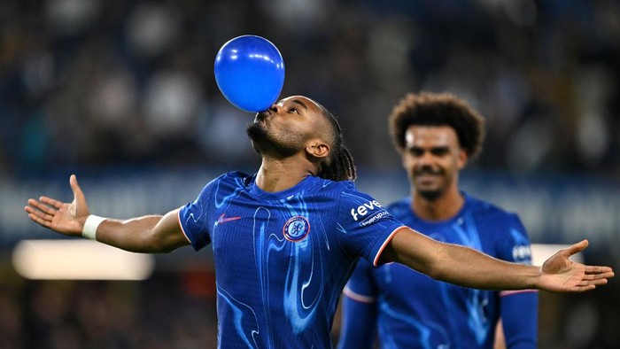 LONDON, ENGLAND - SEPTEMBER 24: Christopher Nkunku of Chelsea celebrates scoring his teams fifth goal, and completing his hattrick by blowing up a ballon during the Carabao Cup Third Round match between Chelsea and Barrow at Stamford Bridge on September 24, 2024 in London, England. (Photo by Mike Hewitt/Getty Images)